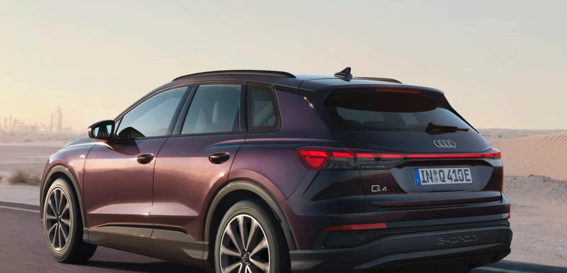 2026 Audi Q4 e-tron MY26 rear three-quarter showing the upright SUV roofline and full-width LED tail-lights