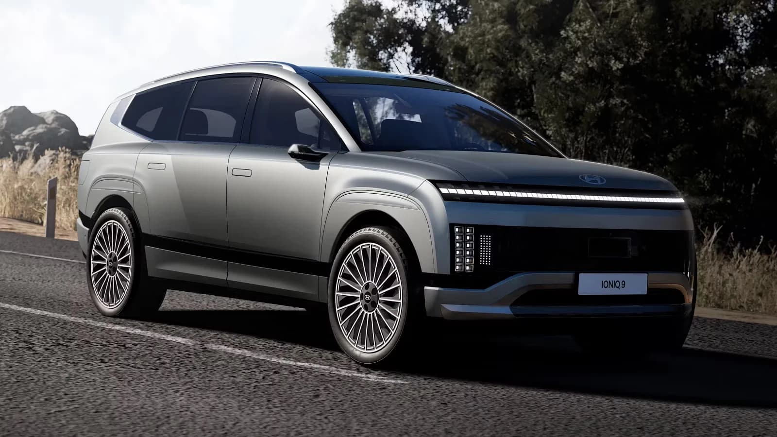 Hyundai Ioniq 9 large electric SUV in matte grey, front three-quarter studio shot