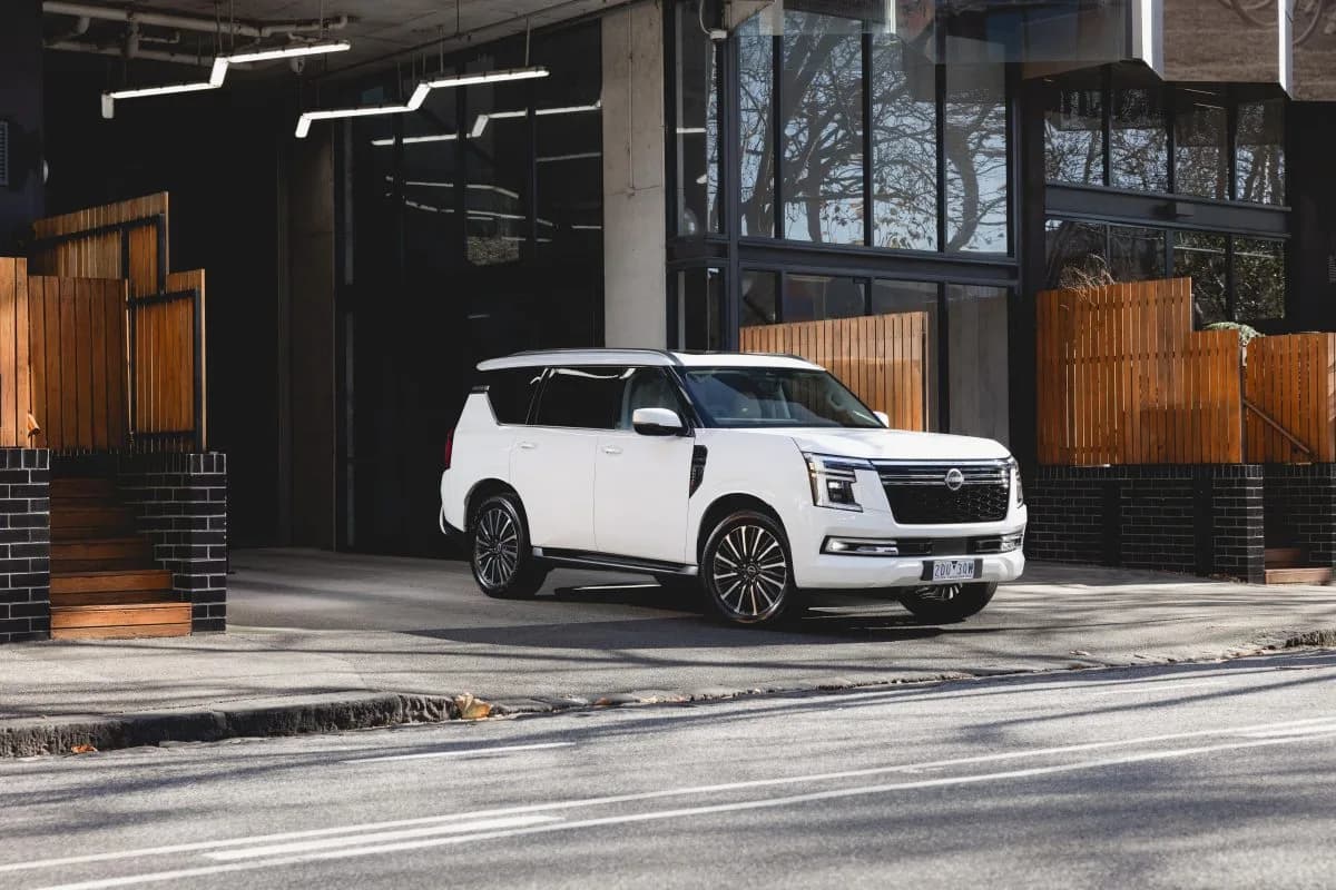 All-new Y63 Nissan Patrol in white, front three-quarter view parked on a city street
