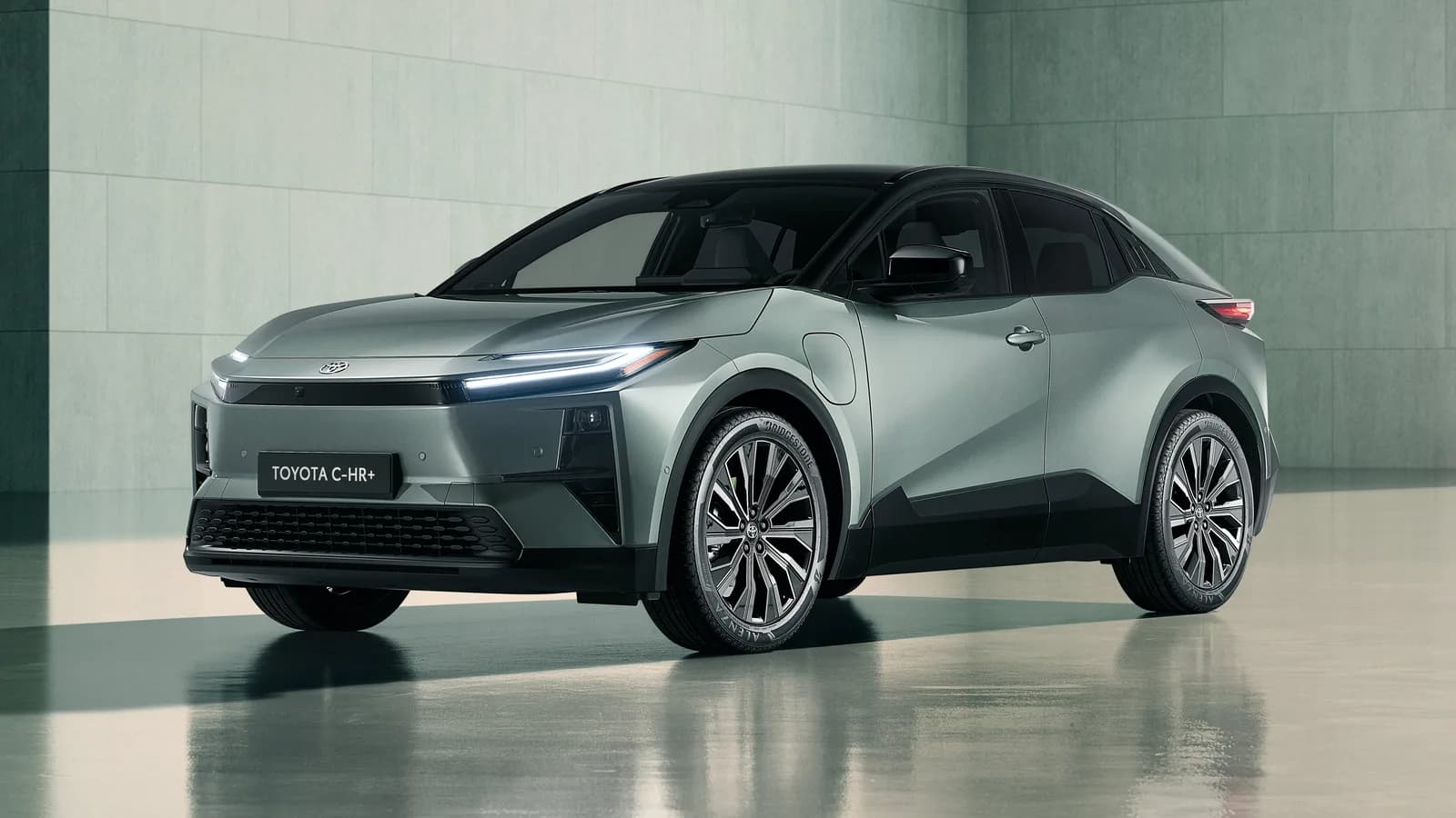 Electric Toyota C-HR in silver in a studio, front three-quarter view