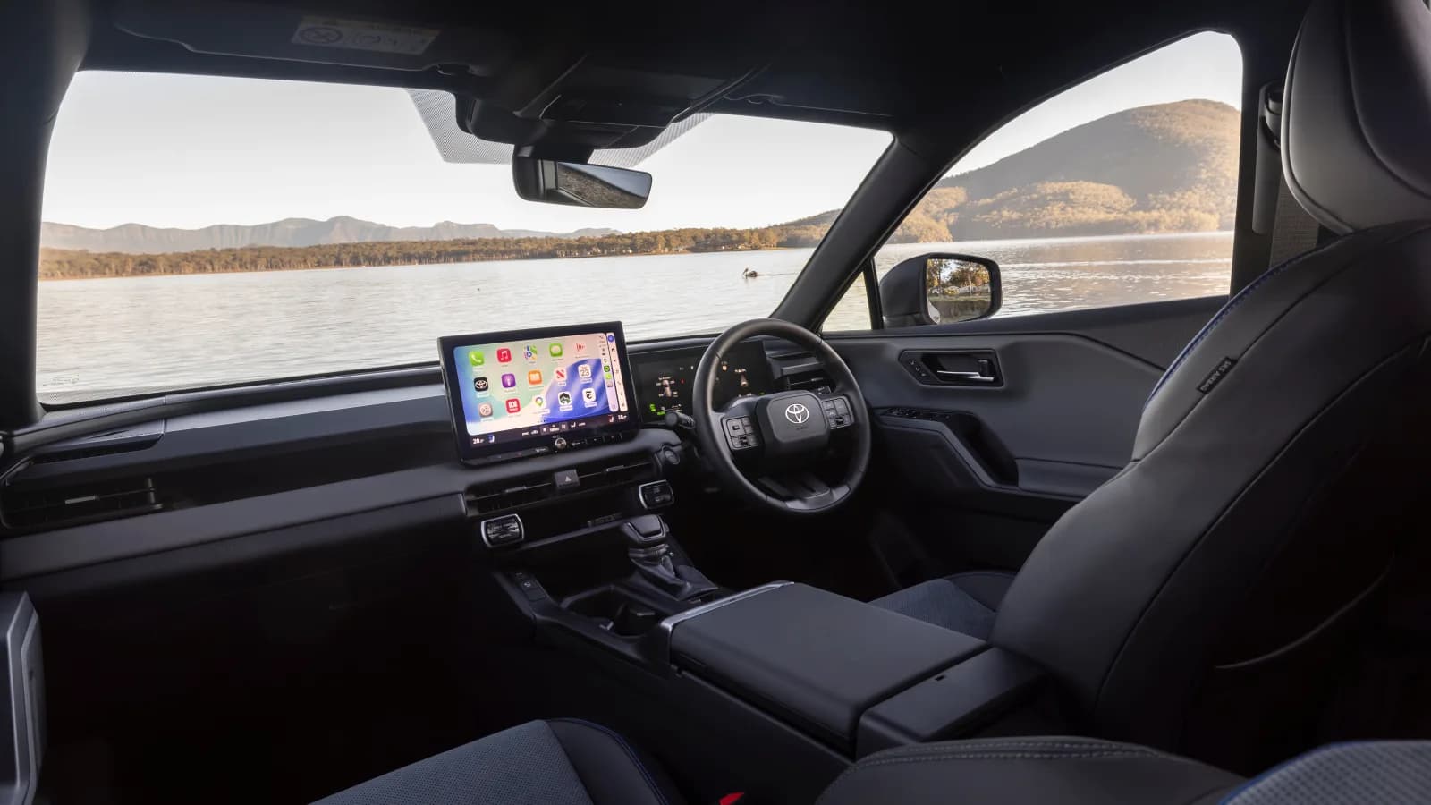 Toyota RAV4 XSE PHEV 2WD cabin, with the digital instrument cluster that displays the warning lights the recall notice mentions if the motor generator ECU does not initialise correctly