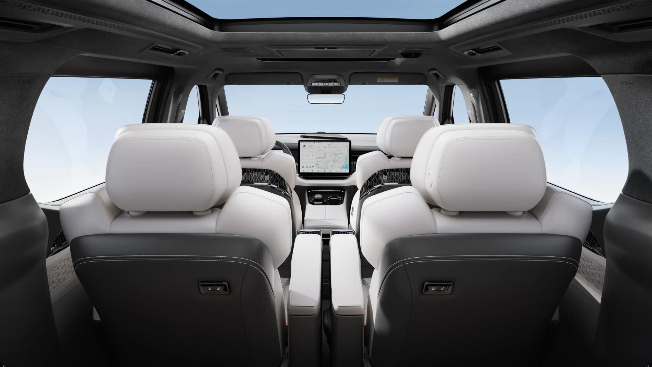 Zeekr 009 cabin viewed from the rear showing dual front screens and panoramic roof