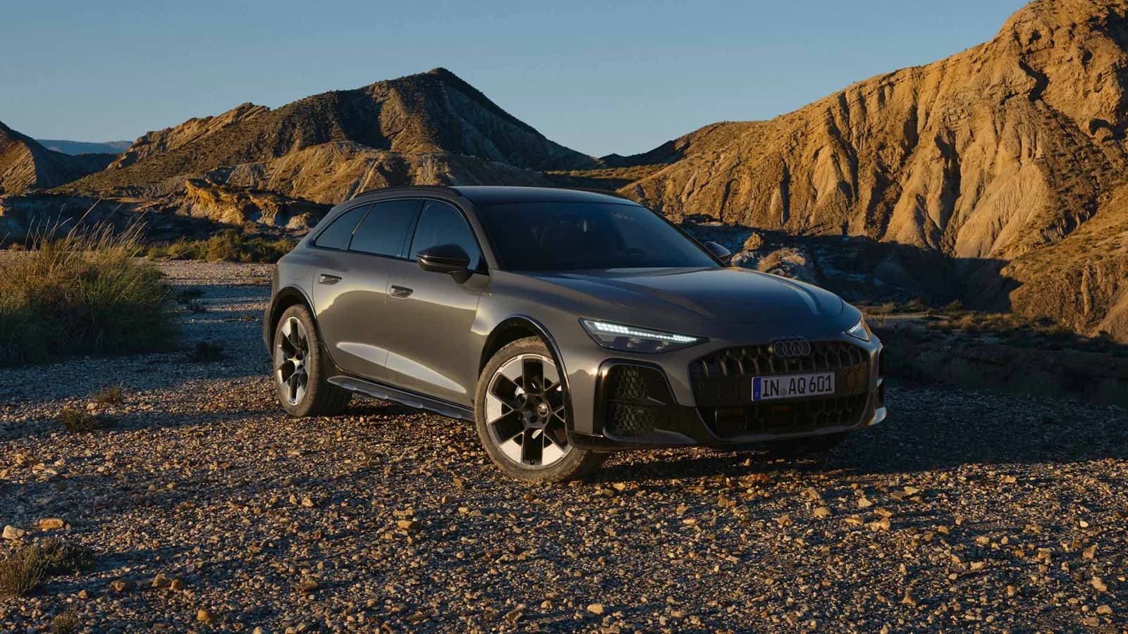 2027 Audi A6 allroad TDI quattro front three-quarter on a gravel desert road