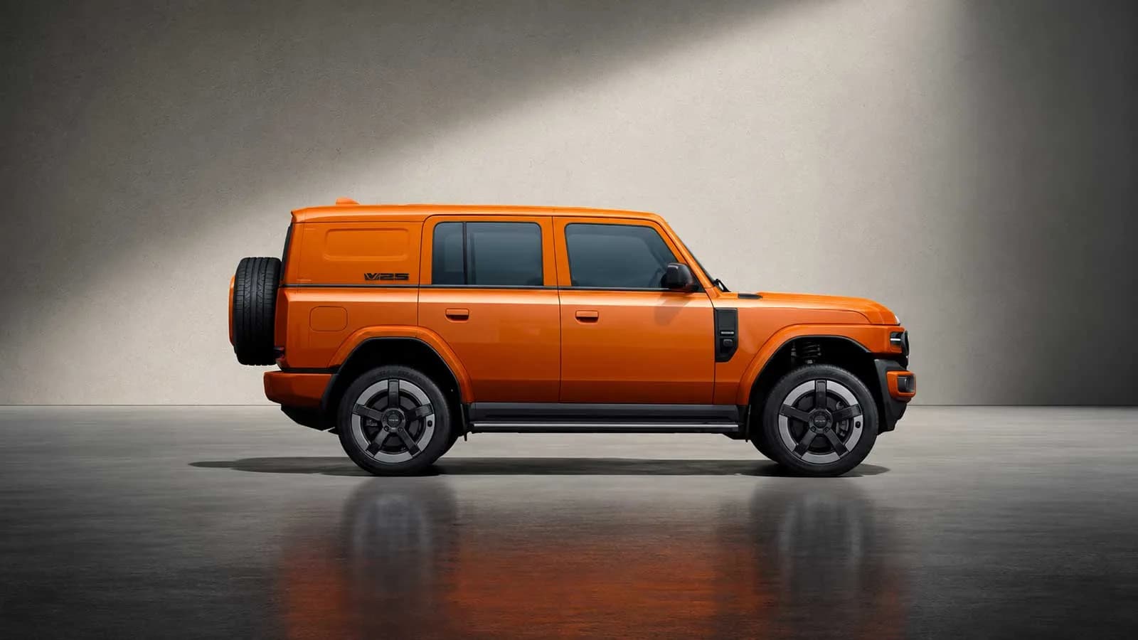 Orange iCAUR V25 in side profile with a full-size spare wheel on the tailgate