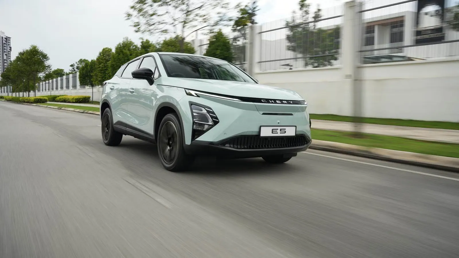 Chery iCar E5 in light green, front three-quarter view driving on road