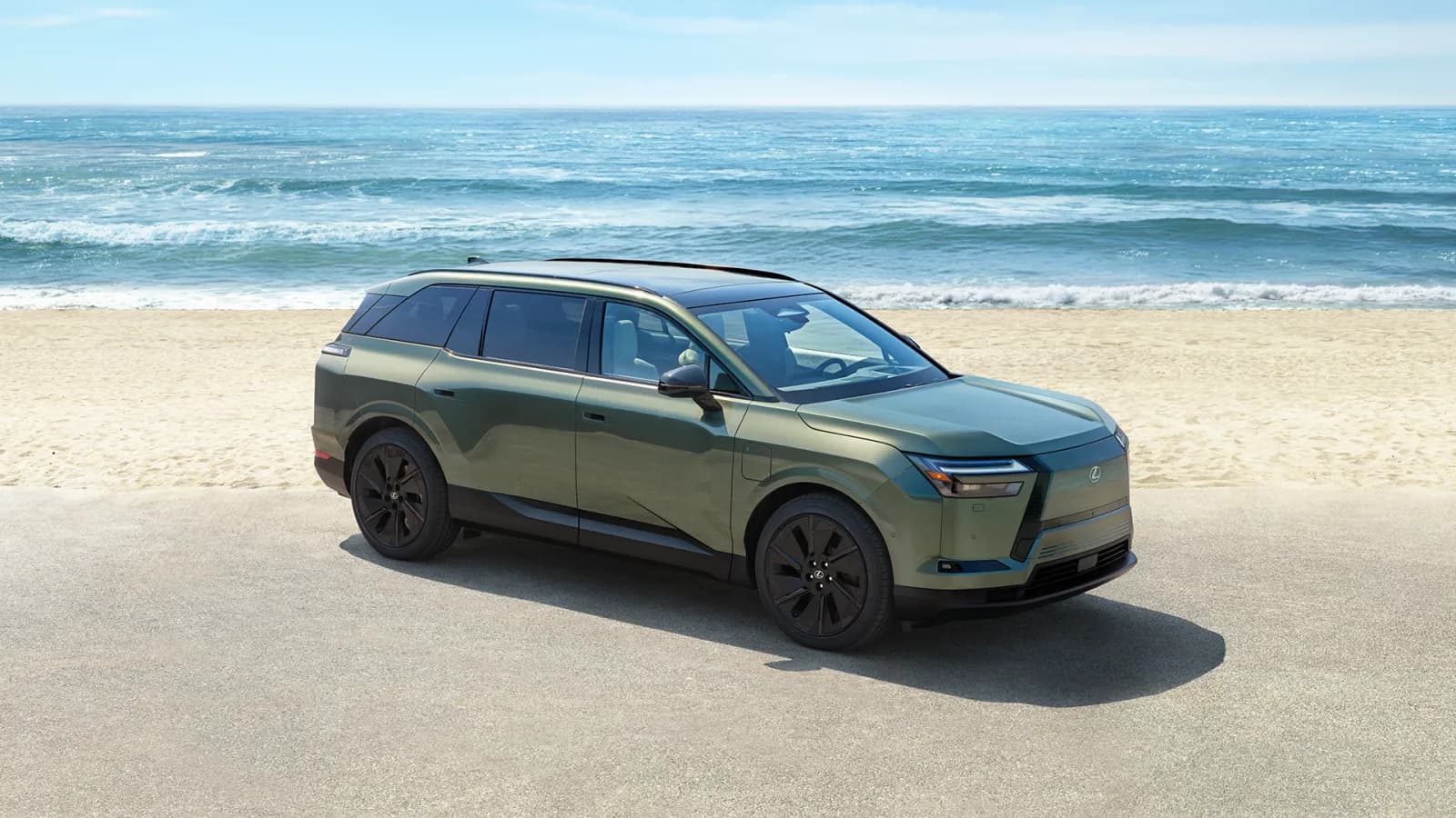 Lexus TZ electric SUV in green parked beside a beach, side and front view from above