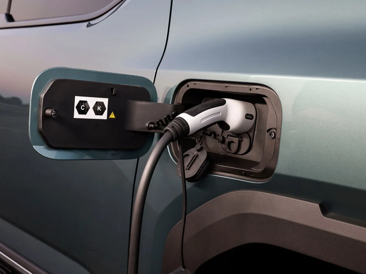 Close-up of the MG U9 EV charge port with a charging connector plugged in