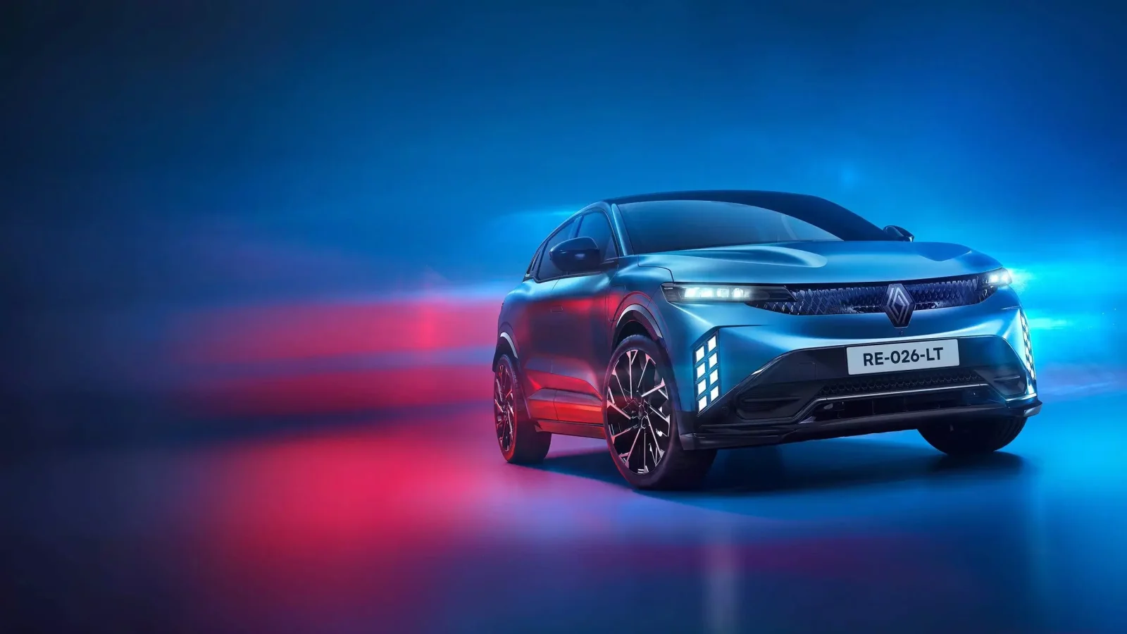 2027 Renault Megane E-Tech esprit Alpine in blue, front three-quarter view in a studio with red and blue light trails