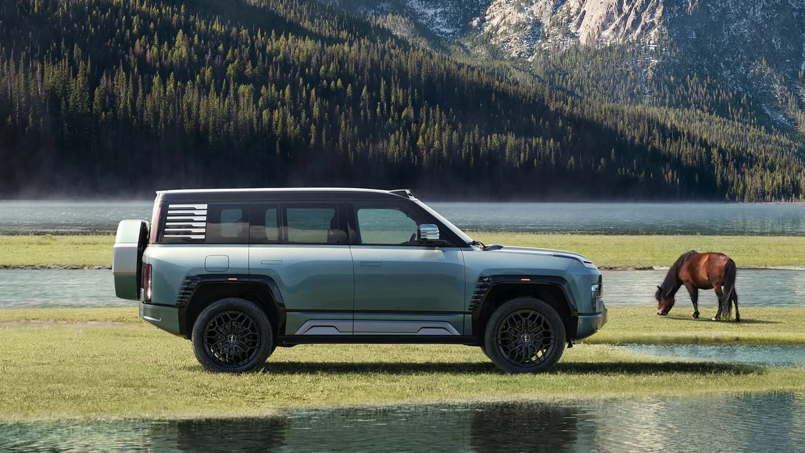 Grey-green Yangwang U8 large SUV in side profile with a rear-mounted spare wheel, parked on grass beside an alpine lake with a horse grazing nearby