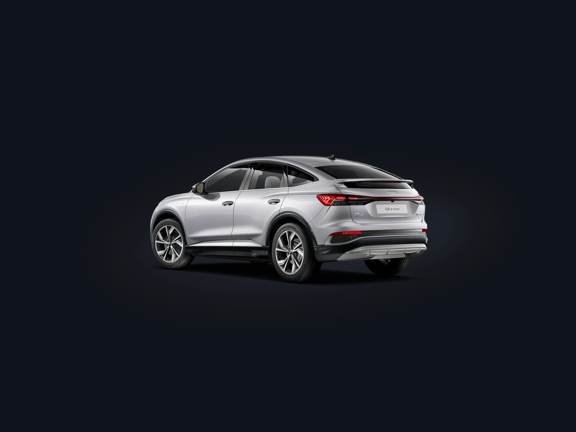 2026 Audi Q4 Sportback e-tron rear quarter showing the sloping coupe roofline and full-width LED light bar