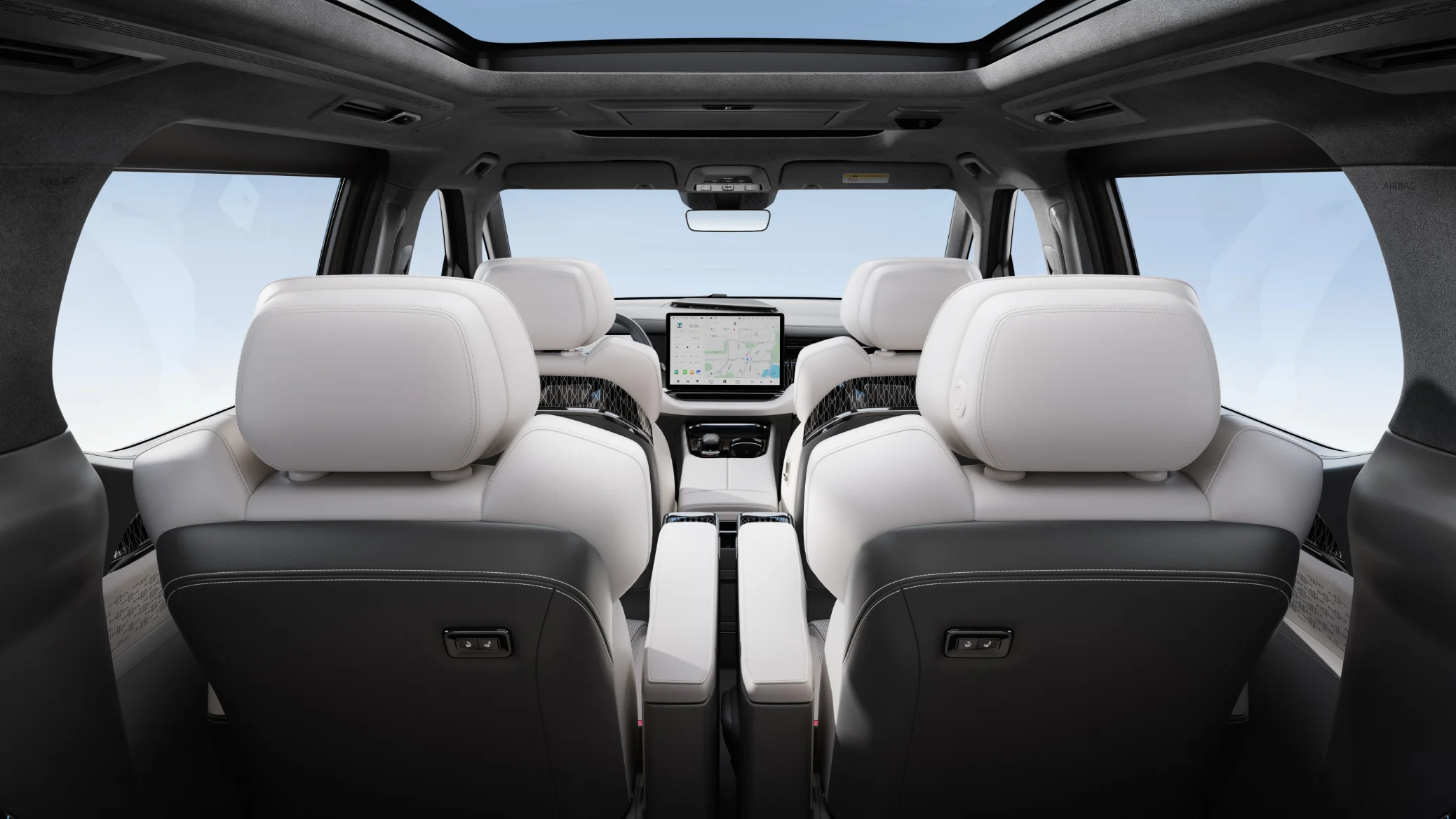 Zeekr 009 cabin viewed from the rear showing dual front screens and panoramic roof