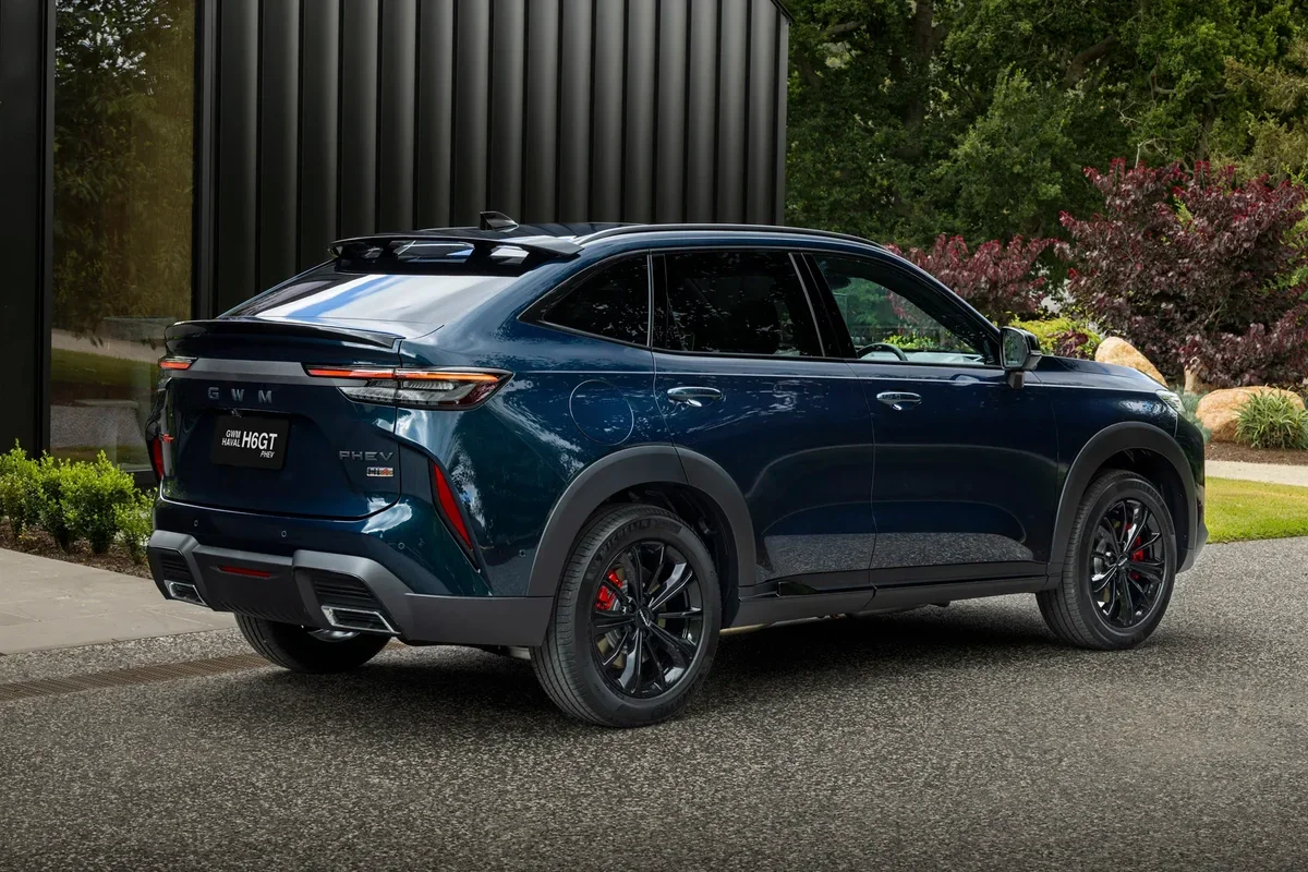 2026 GWM Haval H6GT Hi4 PHEV rear three-quarter showing coupe-SUV roofline and black alloys