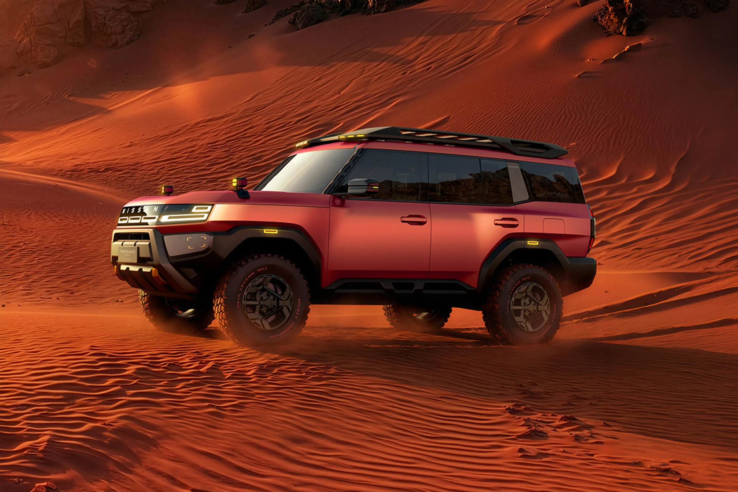 Nissan Terrano PHEV concept driving through orange sand dunes showing off-road capability