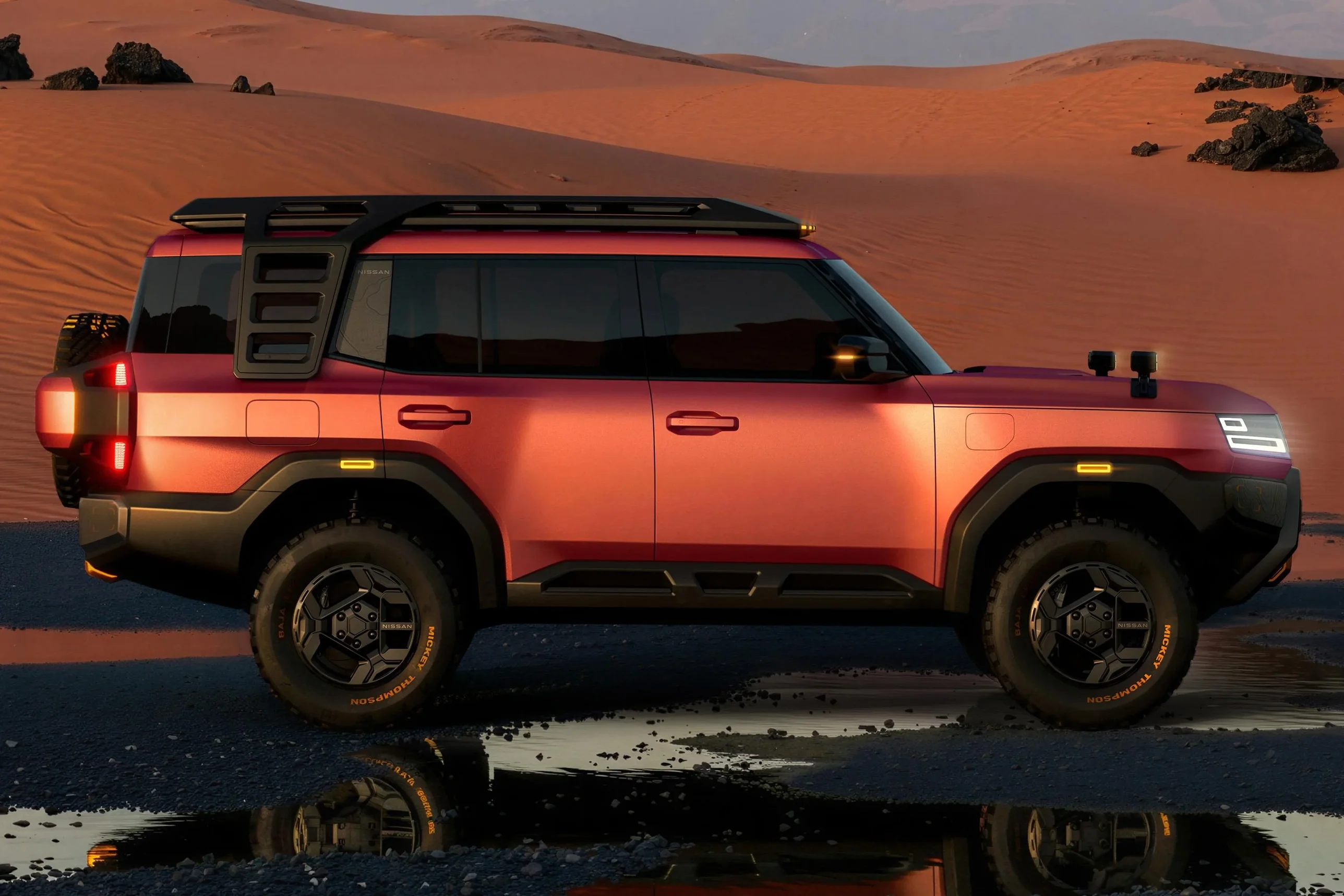 Nissan Terrano PHEV side profile in red with roof rack and chunky all-terrain tyres in desert