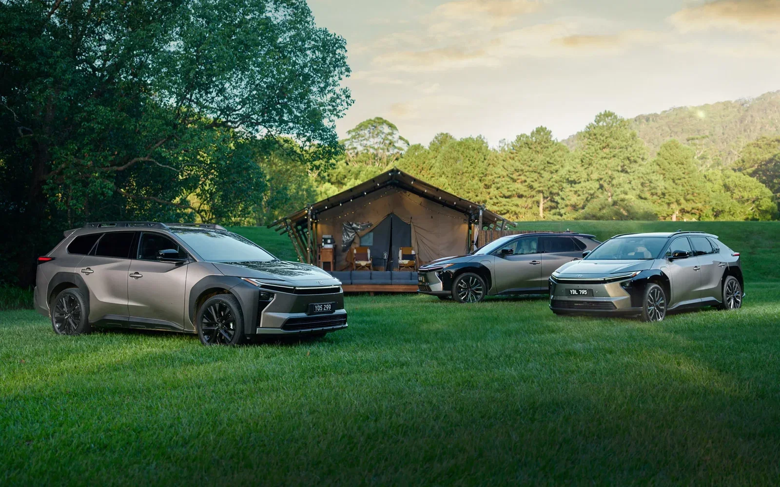 The full Toyota bZ4X family for 2026 lined up beside a glamping tent