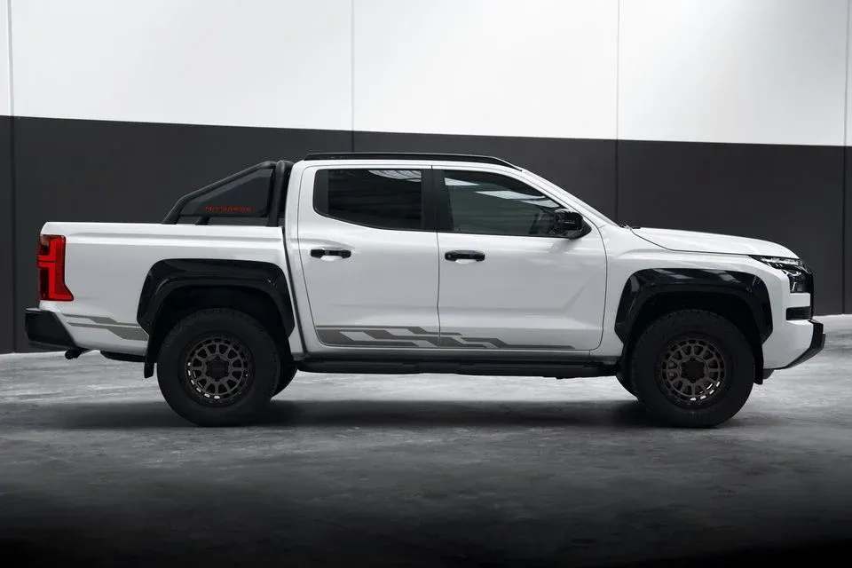 Mitsubishi Triton Raider side profile showing lifted stance and ROH alloys