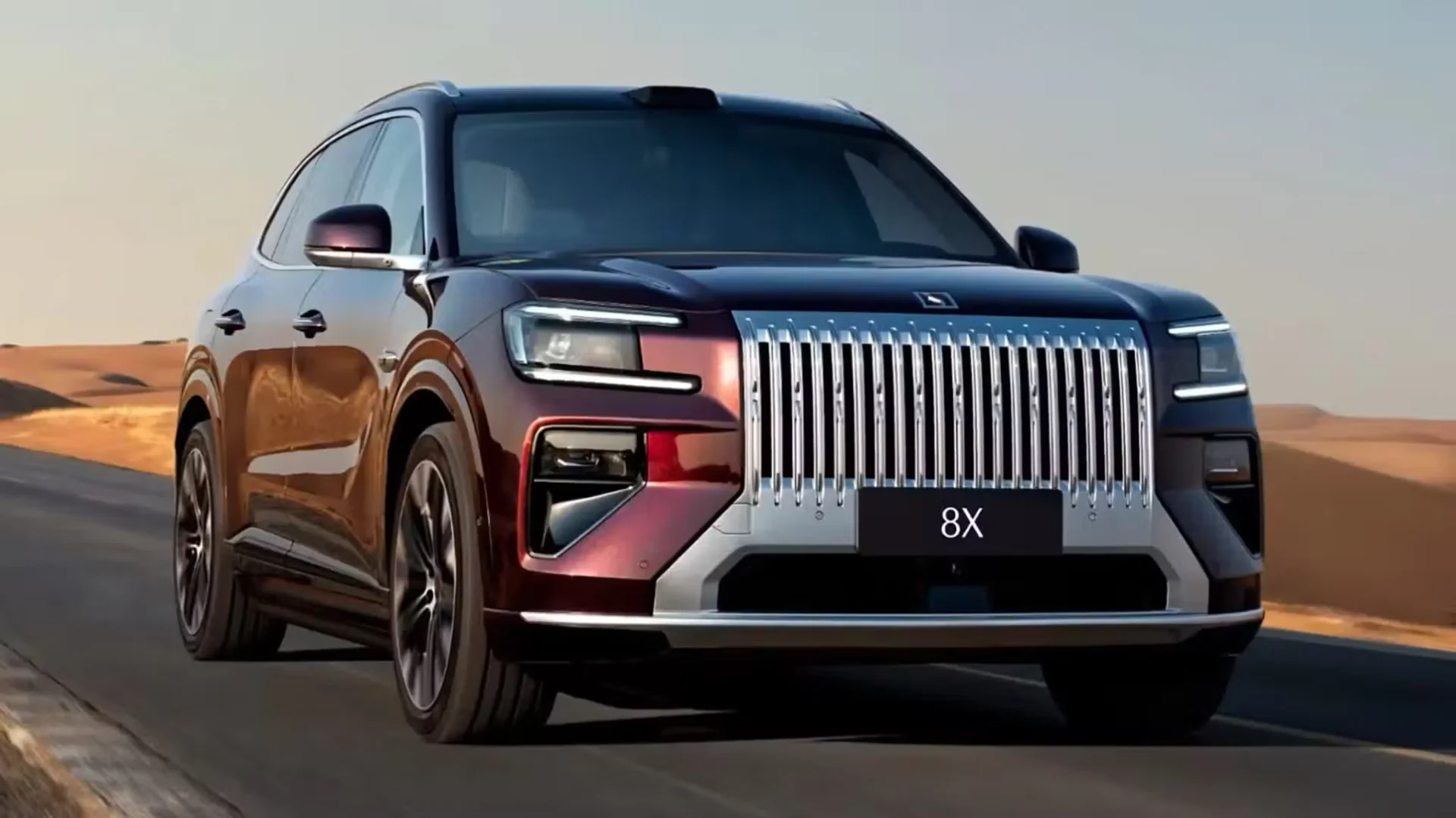 Zeekr 8X extended-range electric SUV in deep red driving through a desert landscape